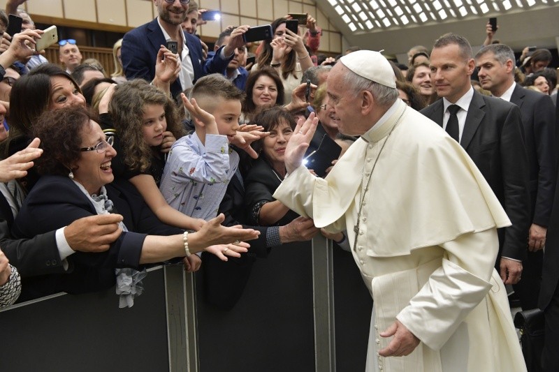 This image has an empty alt attribute; its file name is pope-and-kid-handshake.jpeg